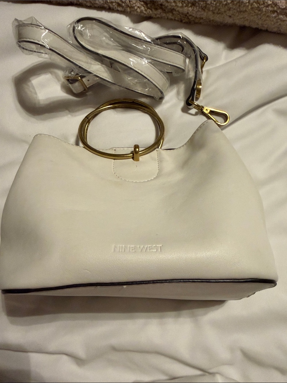Nine West Sannaa cross-body bag features a prominent gold-tone ring handle